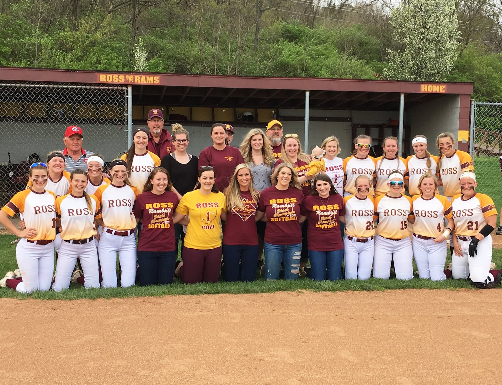 Members of Ross High School’s 2009 Division II state championship softball team pose with players from the 2019 team before Wednesday’s 12-2 victory over visiting Northwest. RICK CASSANO/STAFF