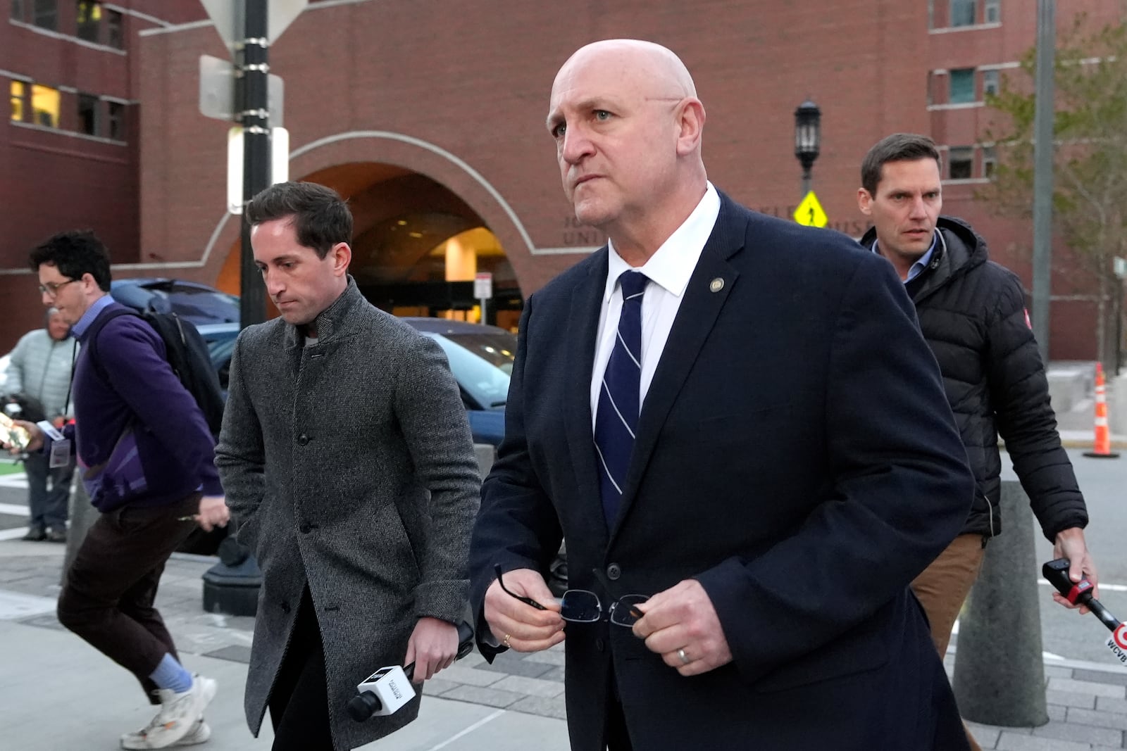 Thomas Dufault, center right, stepfather of Massachusetts Air National Guardsman Jack Teixeira, departs federal court, Tuesday, Nov. 12, 2024, in Boston, following a sentencing hearing for Jack Teixeira. (AP Photo/Steven Senne)