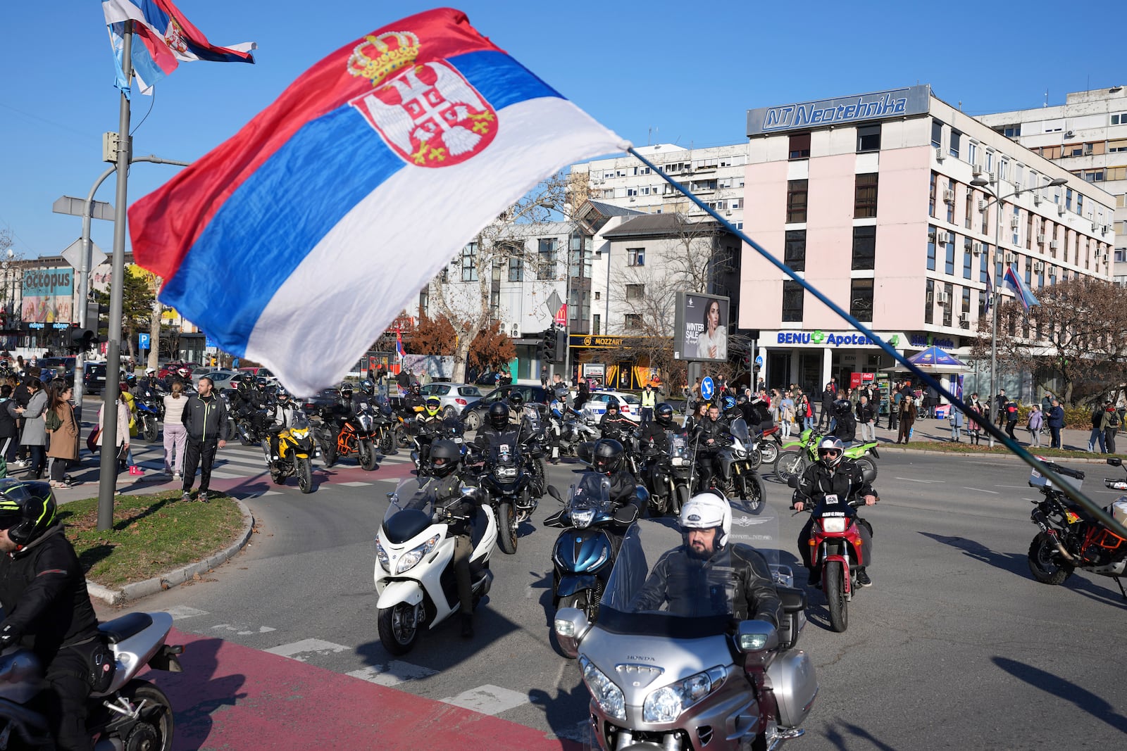 Peopleride their motorcycles during a protest over the collapse of a concrete canopy that killed 15 people more than two months ago, in Novi Sad, Serbia, Saturday, Feb. 1, 2025. (AP Photo/Darko Vojinovic)