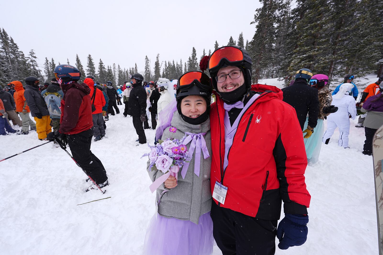 Xiaolin Chen and Carter Poquette hug after being married during the 35th annual Marry Me & Ski for Free Valentine's Day mountaintop matrimony ceremony Friday, Feb. 14, 2025, at Loveland Ski Area, Colo. (AP Photo/David Zalubowski)