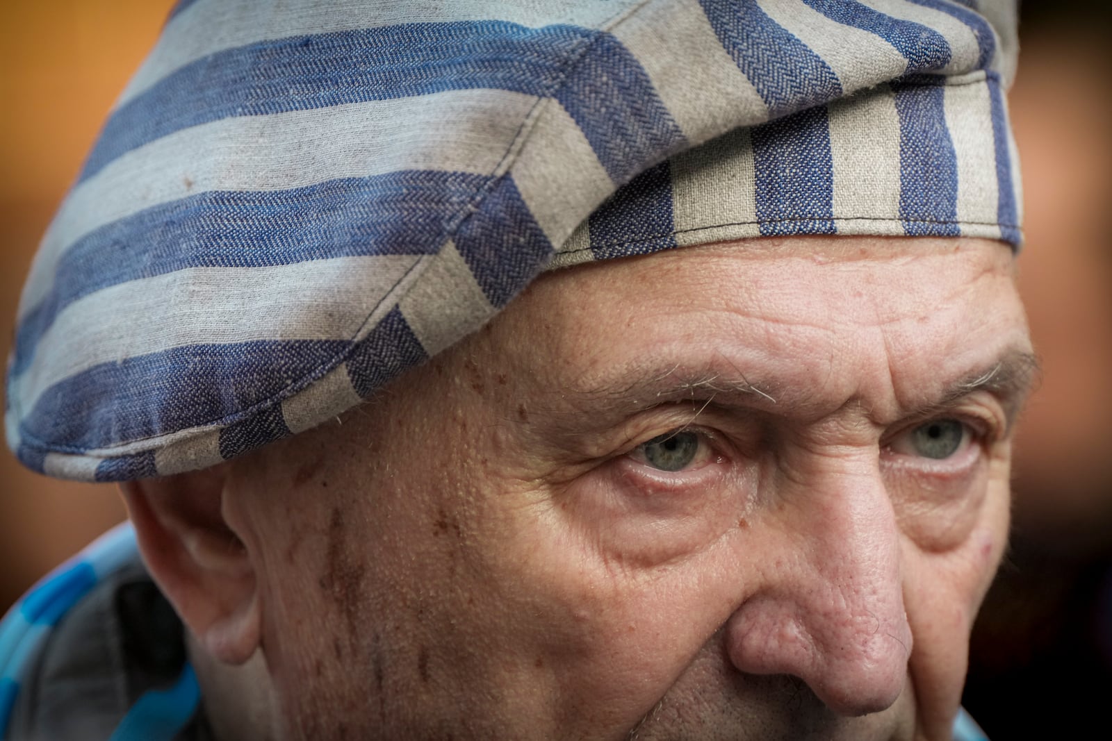 A survivor attends a ceremony at the Auschwitz-Birkenau former Nazi German concentration and extermination camp, in Oswiecim, Poland, Monday, Jan. 27. 2025. (AP Photo/Oded Balilty)