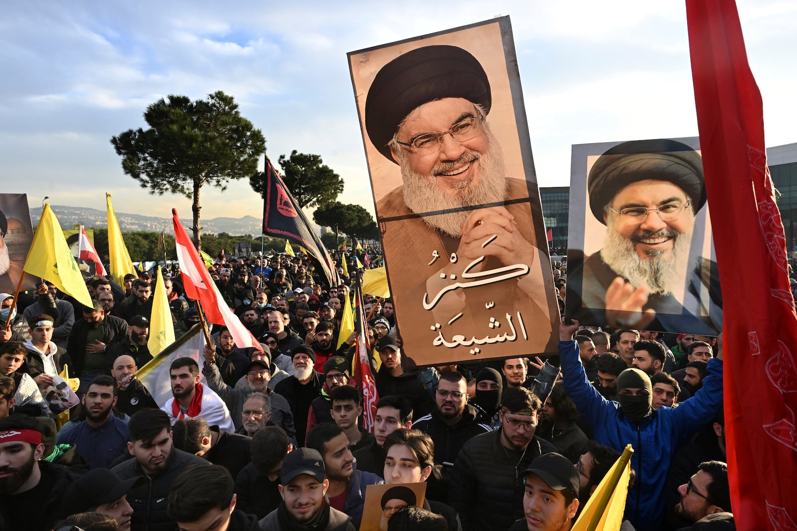 Hezbollah supporters hold up portraits of the slain Hezbollah leader Sayyed Hassan Nasrallah with Arabic words that read: "The treasure of Shiite", as they protest near Beirut's international airport against Lebanon's decision to revoke permission for an Iranian carrier after Israel accused Iran of smuggling cash to Hezbollah, in Beirut, Lebanon, Saturday, Feb. 15, 2025. (AP Photo)