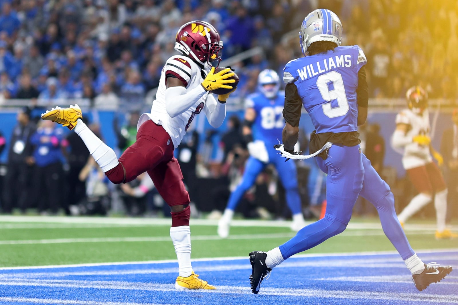 Washington Commanders cornerback Mike Sainristil (0) intercepts a pass intended for Detroit Lions wide receiver Jameson Williams (9) during the first half of an NFL football divisional playoff game, Saturday, Jan. 18, 2025, in Detroit. (AP Photo/Mike Mulholland)