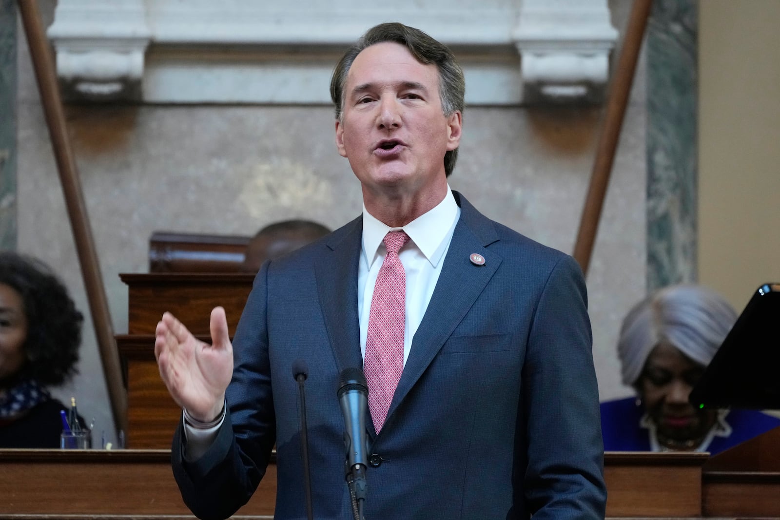 FILE - Virginia Gov. Glenn Youngkin gestures as he delivers his annual State of the Commonwealth address before a joint session of the Virginia General Assembly at the Capitol, Jan. 13, 2025 in Richmond, Va. (AP Photo/Steve Helber, file)