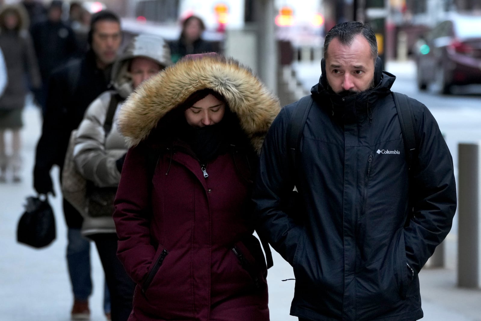 Commuters head to work as an Arctic blast brings single-digit temperatures with wind chills below zero on Thursday, Dec. 12, 2024, in Chicago. (AP Photo/Charles Rex Arbogast)