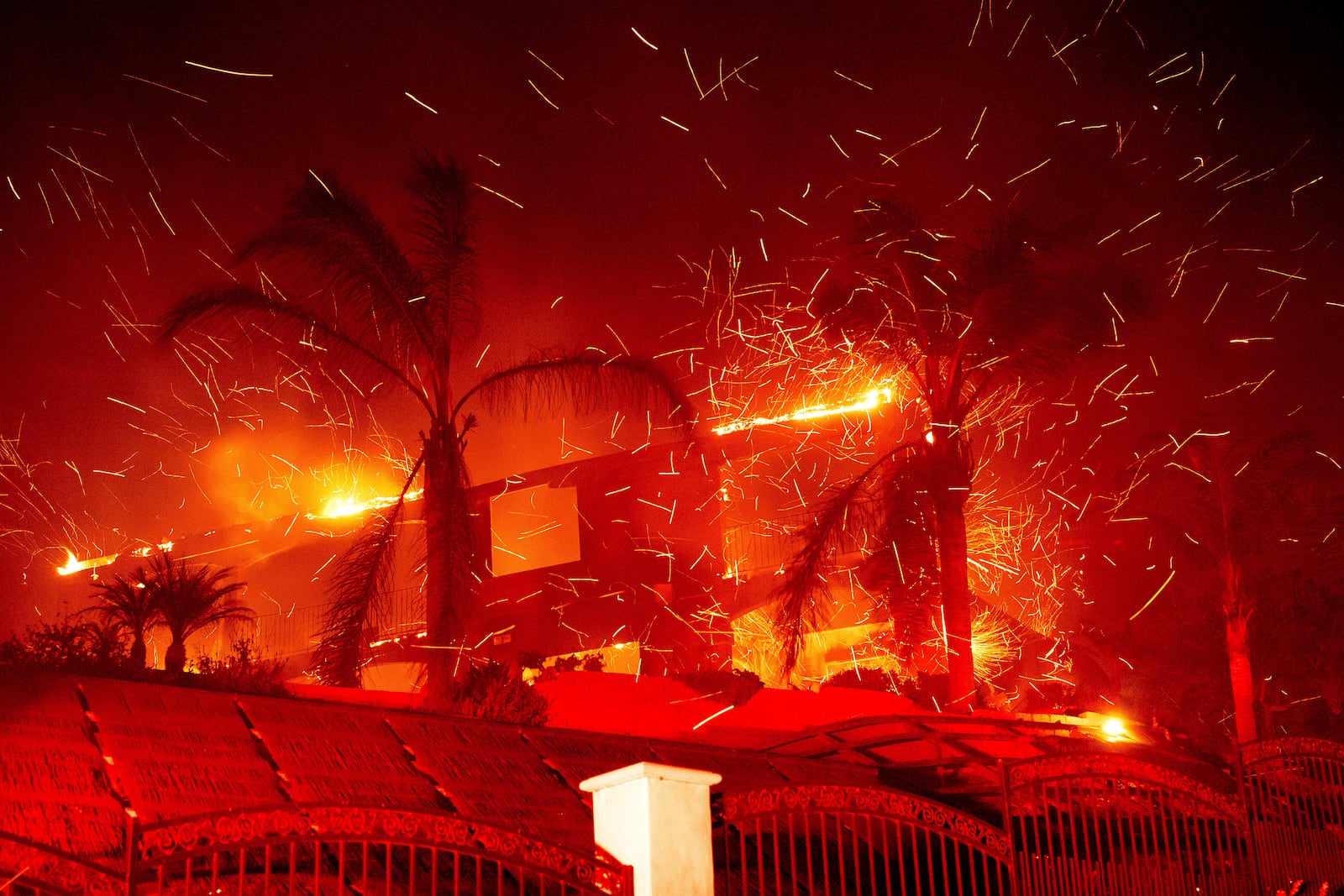 Flames consume a home as the Mountain Fire burns in Camarillo, Calif., on Wednesday, Nov. 6, 2024. (AP Photo/Noah Berger)