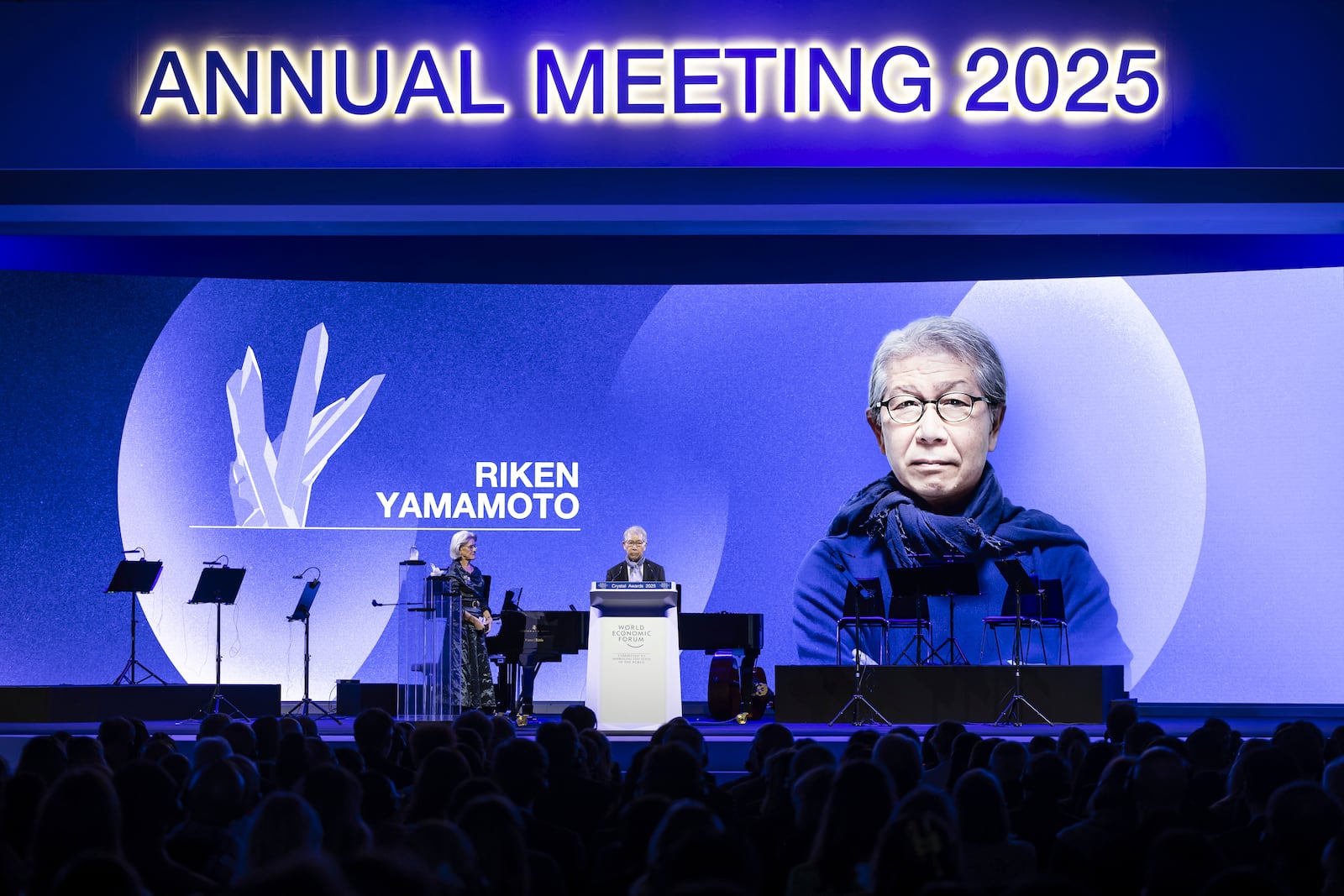 Riken Yamamoto, Founder and Architect, Riken Yamamoto & Field Shop, speaks next to Hilde Schwab, Chairperson and Co-Founder, Schwab Foundation for Social Entrepreneurship, left, after receiving a Crystal Award during the ceremony for the Crystal Awards at the 55th annual meeting of the World Economic Forum, WEF, in Davos, Switzerland, on Monday, Jan. 20, 2025. (Michael Buholzer/Keystone via AP)