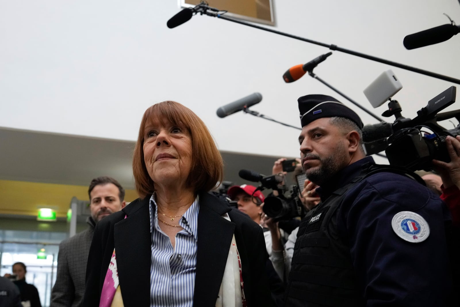 Gisele Pelicot, who was allegedly drugged by her now former husband so that he and others could assault her, arrives at the court house in Avignon, southern France, Thursday, Dec. 19, 2024. (AP Photo/Lewis Joly)