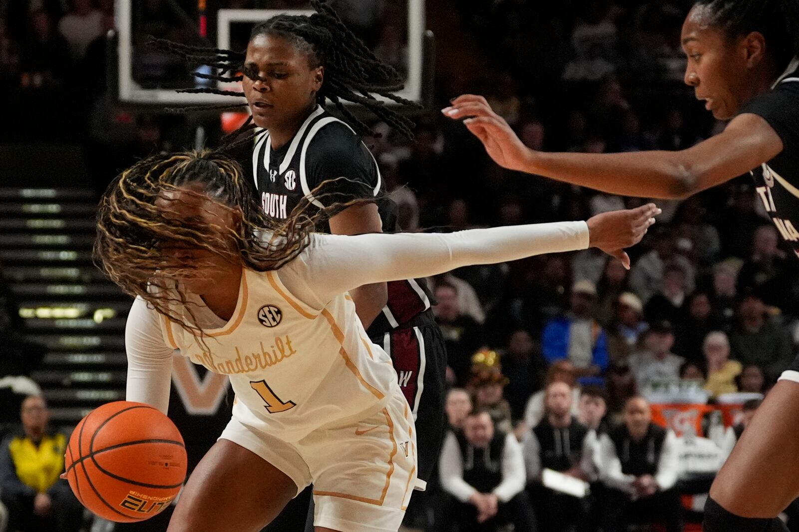 Vanderbilt guard Mikayla Blakes (1) dribbles the ball past South Carolina defenders during the first half of an NCAA college basketball game Sunday, Feb. 23, 2025, in Nashville, Tenn. (AP Photo/George Walker IV)