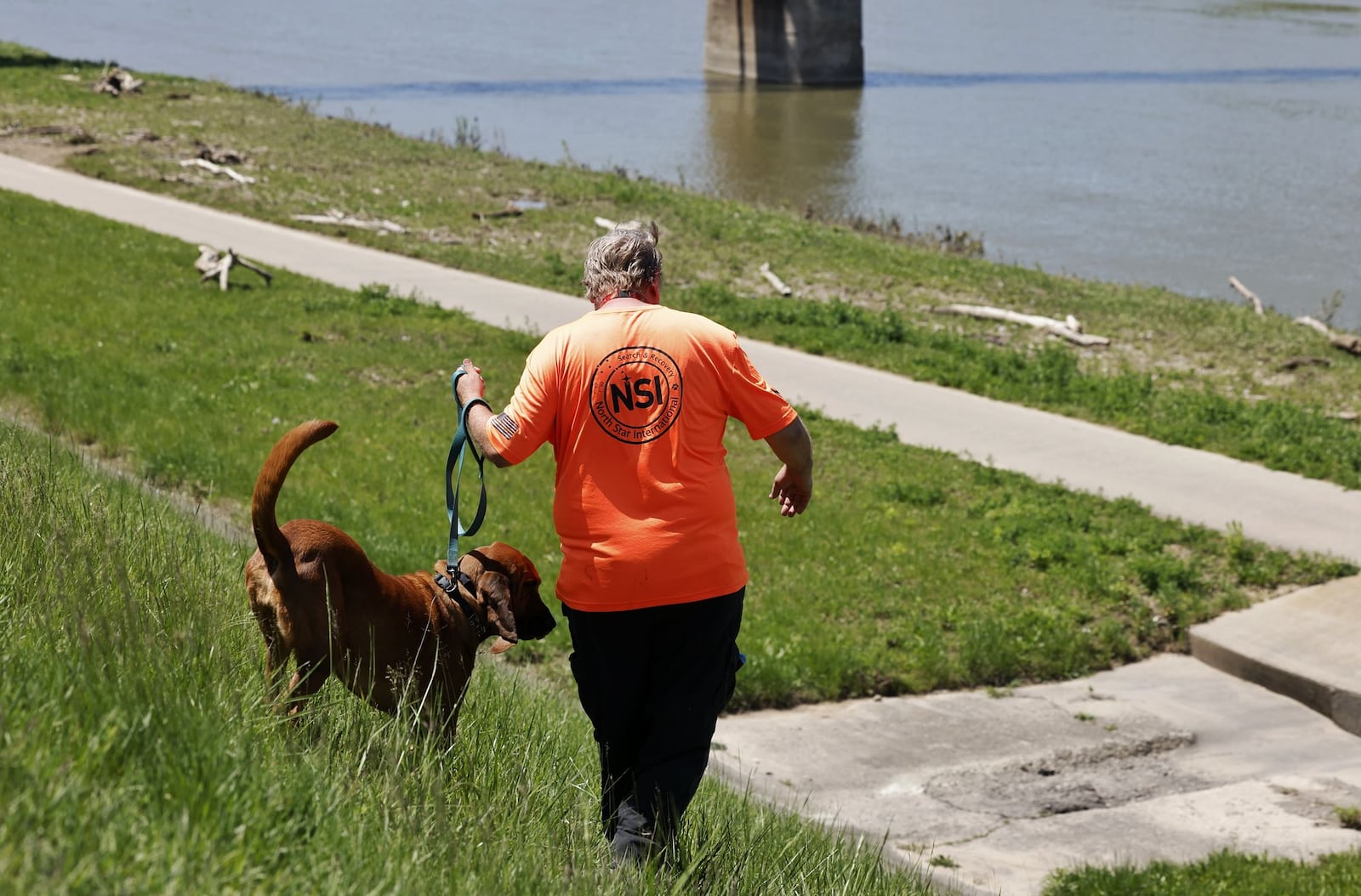 Law enforcement agencies and volunteers search the Great Miami River Tuesday, May 9, 2022 for a person who fled into the river. Butler County Sheriff's Office crews are searching by boat and a group from North Star Seach and Rescue has canines out searching along the river banks. NICK GRAHAM/STAFF