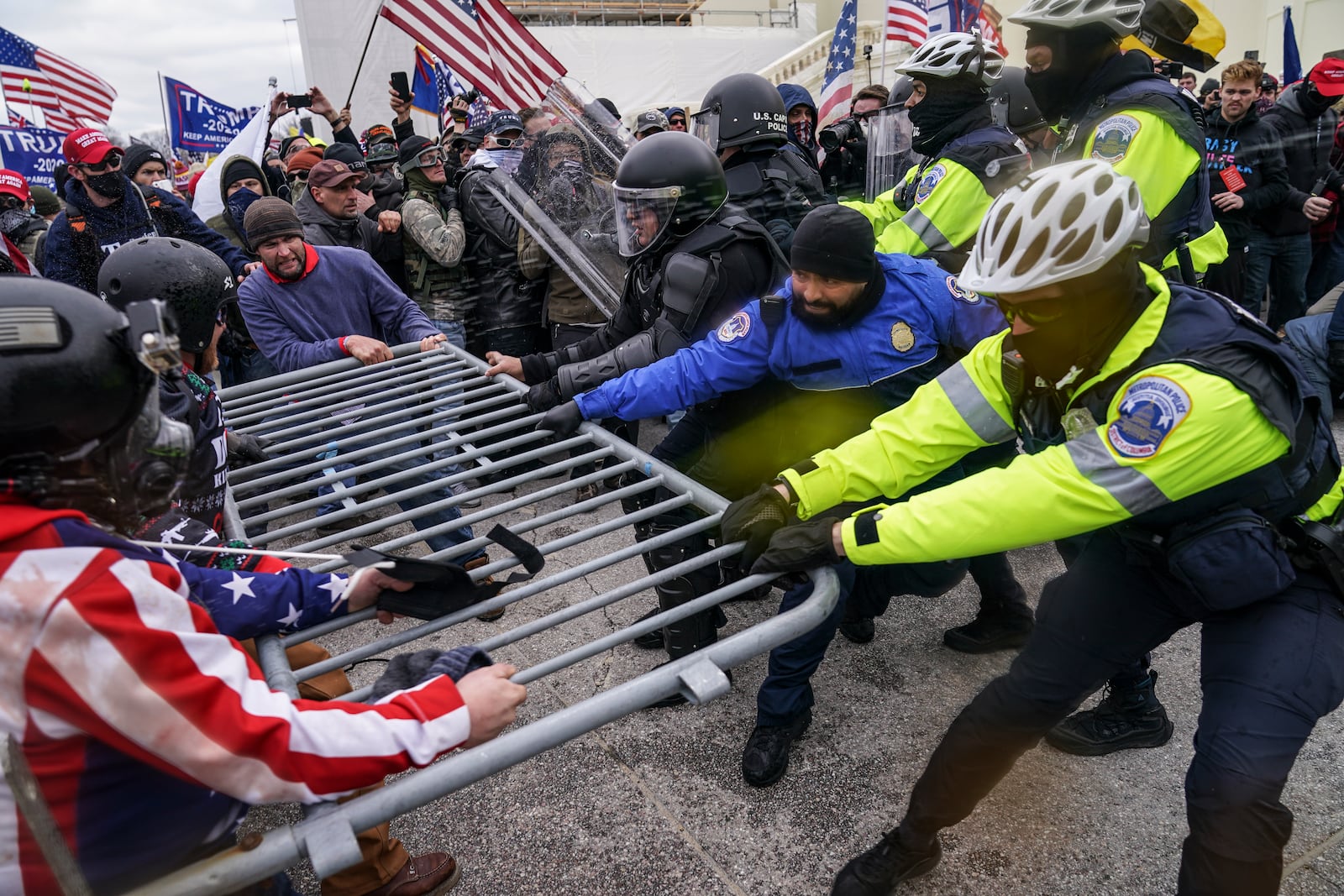 FILE - Supporters of President Donald Trump try to break through a police barrier, Jan. 6, 2021, during a riot at the Capitol in Washington. Former President Donald Trump said during a debate with President Joe Biden last week that the attack on the Capitol involved a "relatively small" group of people who were "in many cases ushered in by the police." (AP Photo/John Minchillo)