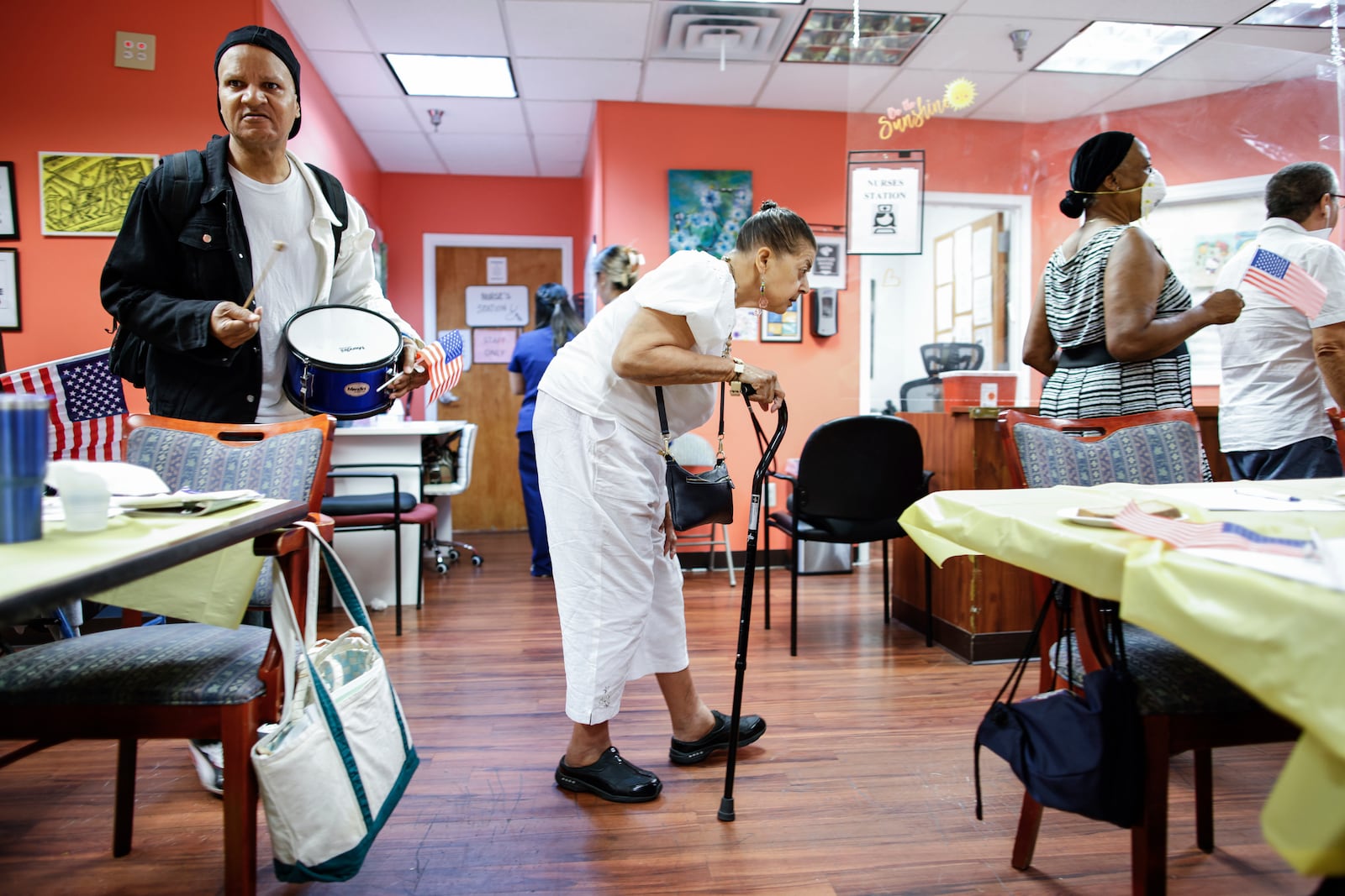 People take part in a multicultural parade inside Sunshine Adult Day Center in Bergenfield, N.J., Monday, Aug. 26, 2024. (AP Photo/Kena Betancur)