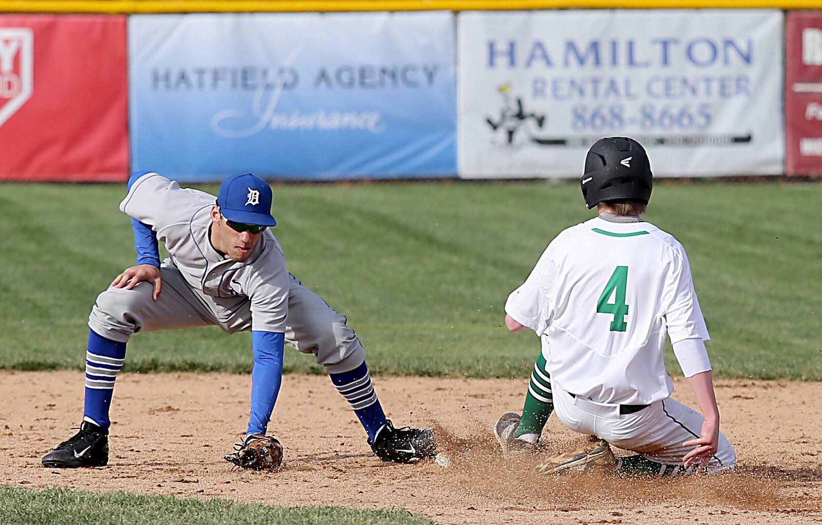 Badin’s Gavin Matthews beats the throw to Defiance shortstop Charlie Gordon after a wild pitch during Wednesday’s game at Alumni Field in Hamilton. CONTRIBUTED PHOTO BY E.L. HUBBARD