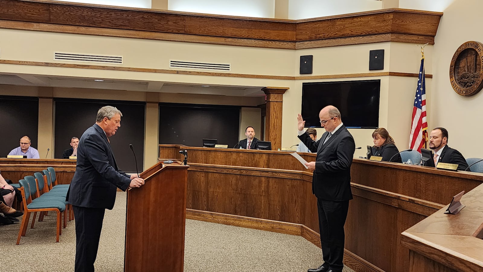 Monroe Law Director K. Philip Callahan swears in Larry Lester as Monroe's city manager during Tuesday night's council meeting. SUBMITTED PHOTO