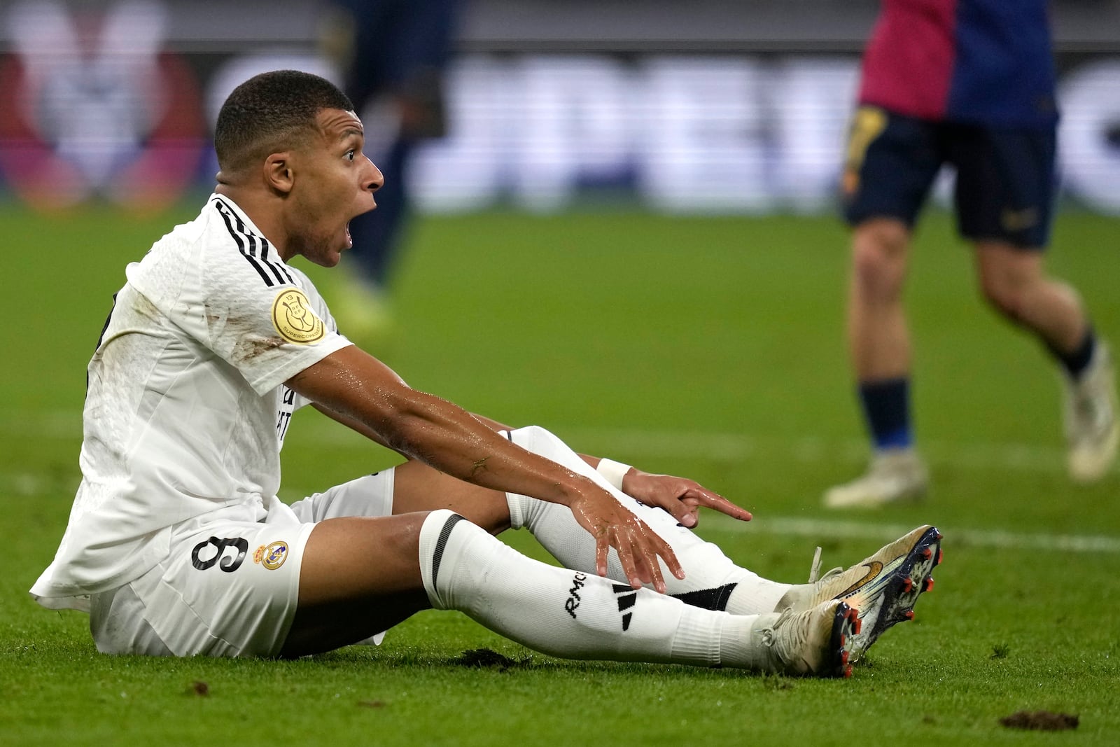 Real Madrid's Kylian Mbappe reacts during the Spain Super Cup final soccer match between Real Madrid and Barcelona at King Abdullah Stadium in Jeddah, Saudi Arabia, Sunday, Jan. 12, 2025. (AP Photo/Altaf Qadri)