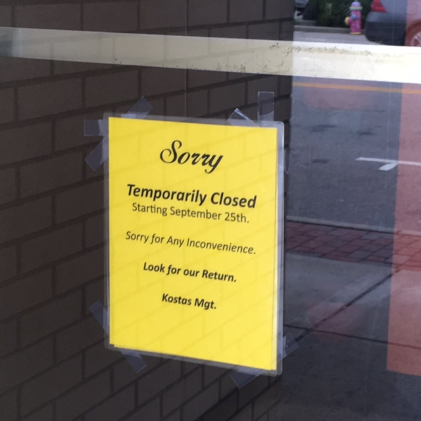 A sign on the door of Kostas Restaurant in Hamilton indicates it is temporarily closed. 