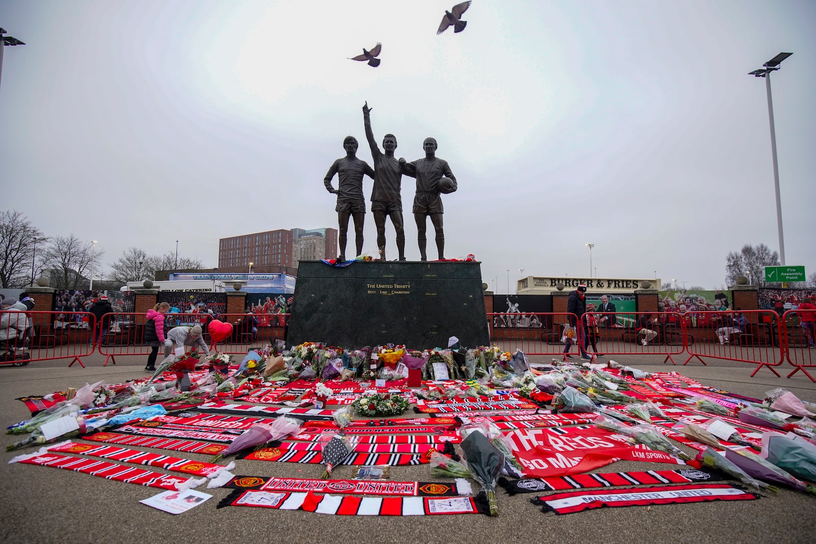 A statue of Manchester United trio of George Best, left, Denis Law, center, and Sir Bobby Charlton is seen prior the English Premier League soccer match between Manchester United and Brighton and Hove Albion, at the Old Trafford stadium in Manchester, England, Sunday, Jan. 19, 2025. (AP Photo/Dave Thompson)