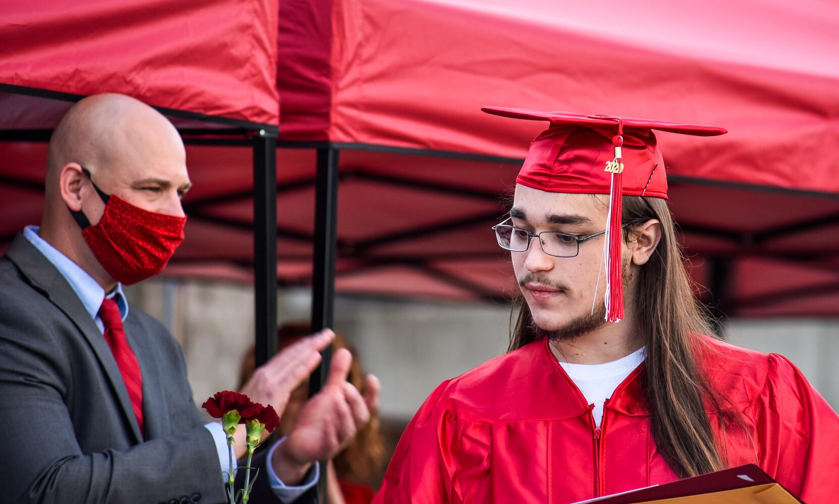 Madison High School drive-thru graduation ceremony at Land of Illusion