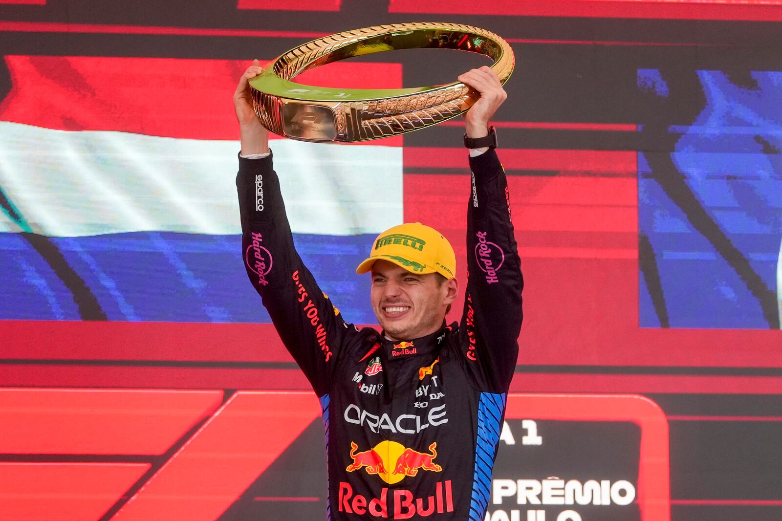 Red Bull driver Max Verstappen, of the Netherlands, celebrates on the podium his first place in the Brazilian Formula One Grand Prix at the Interlagos race track in Sao Paulo, Sunday, Nov. 3, 2024. (AP Photo/Andre Penner)