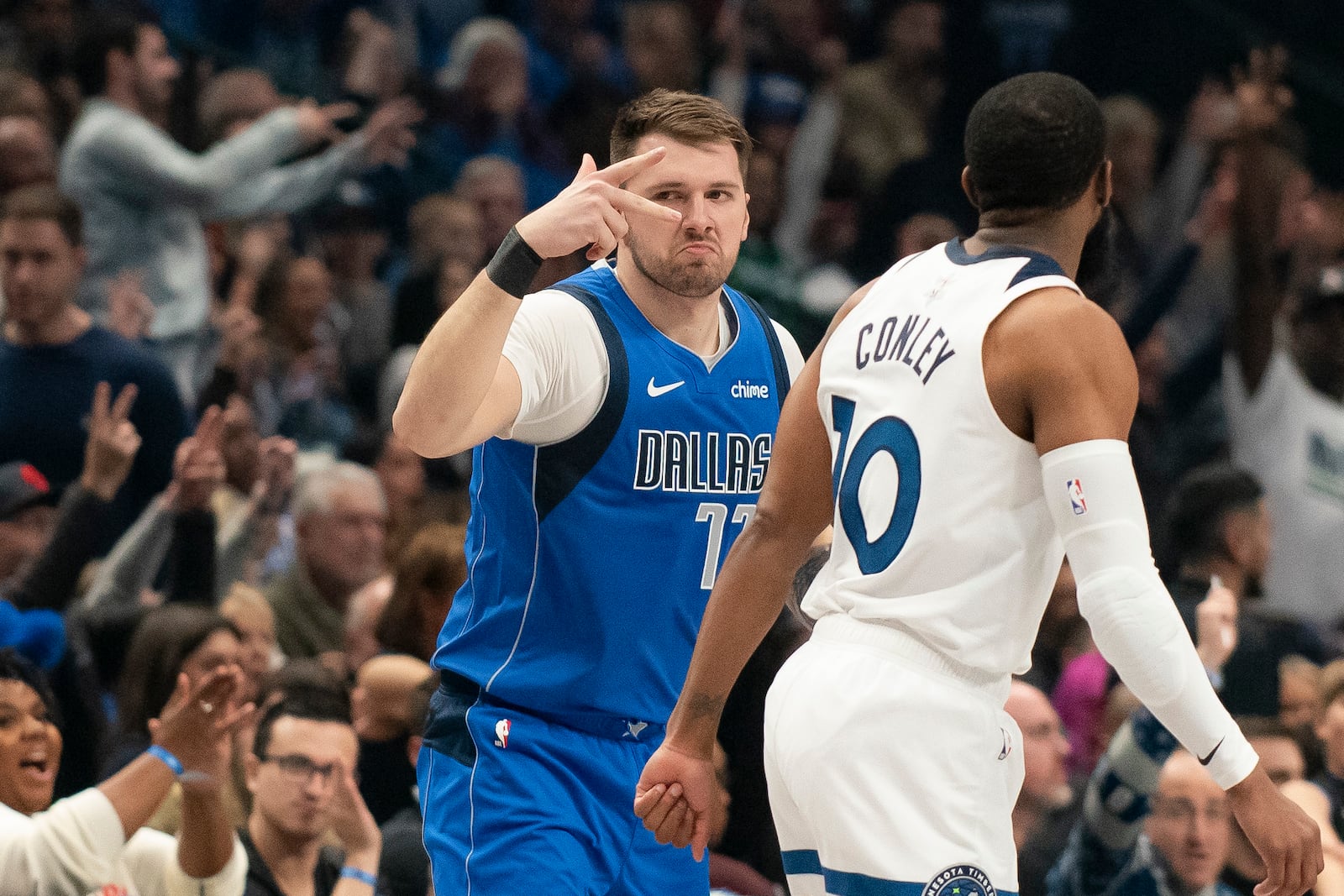 Dallas Mavericks guard Luka Doncic (77) celebrates after hitting a three-pointer over Minnesota Timberwolves guard Mike Conley (10) in the first half of an NBA basketball game on Wednesday, Dec. 25, 2024, in Dallas. (AP Photo/Emil T. Lippe)