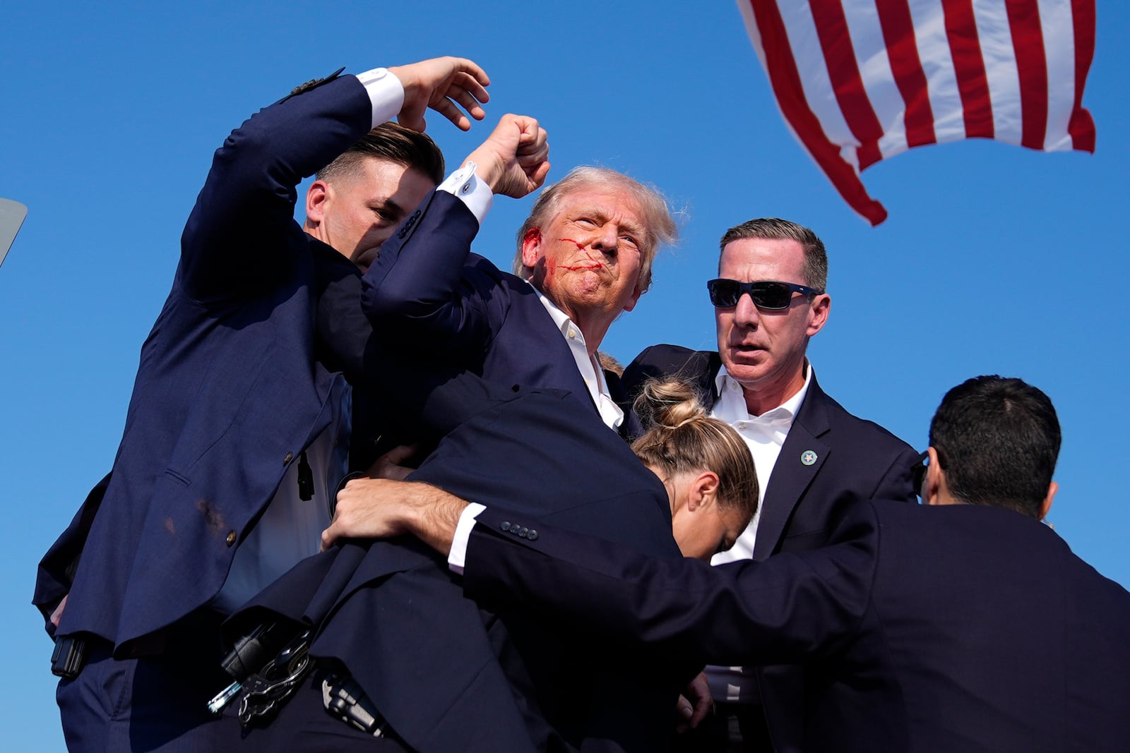 Republican presidential candidate former President Donald Trump is surrounded by U.S. Secret Service agents at a campaign rally, July 13, 2024, in Butler, Pa. (AP Photo/Evan Vucci, File)