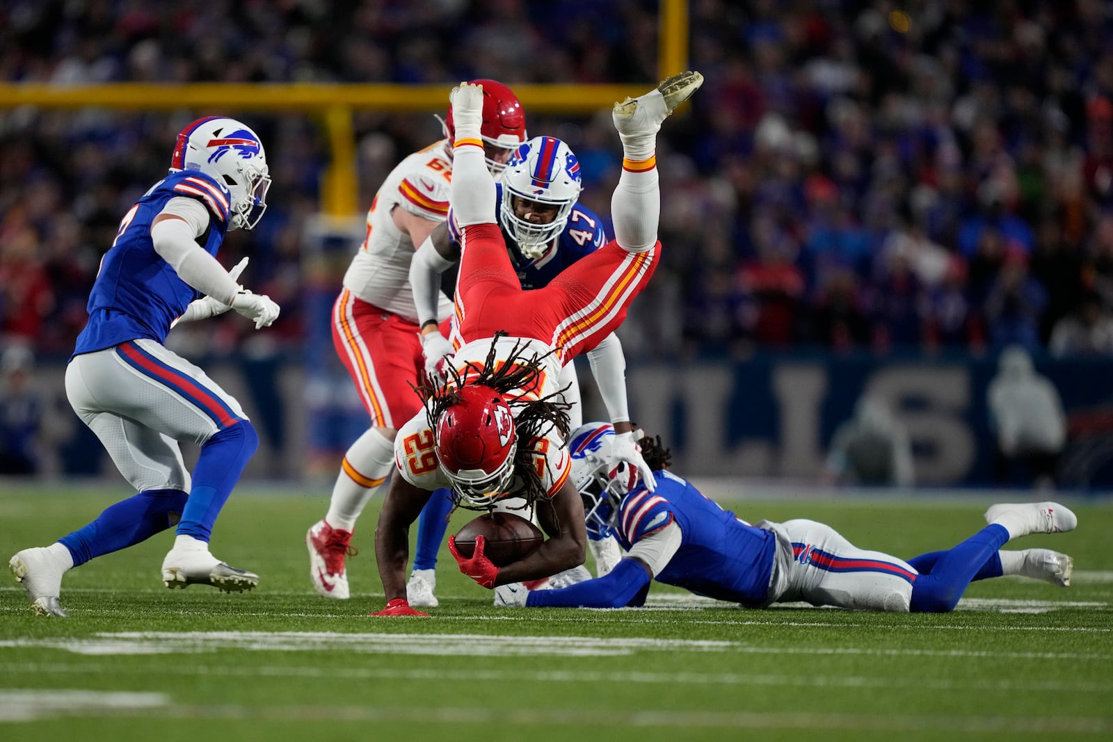 Kansas City Chiefs running back Kareem Hunt (29) leaps over Buffalo Bills safety Damar Hamlin, right, during the first half of an NFL football game Sunday, Nov. 17, 2024, in Orchard Park, N.Y. (AP Photo/Julia Demaree Nikhinson)