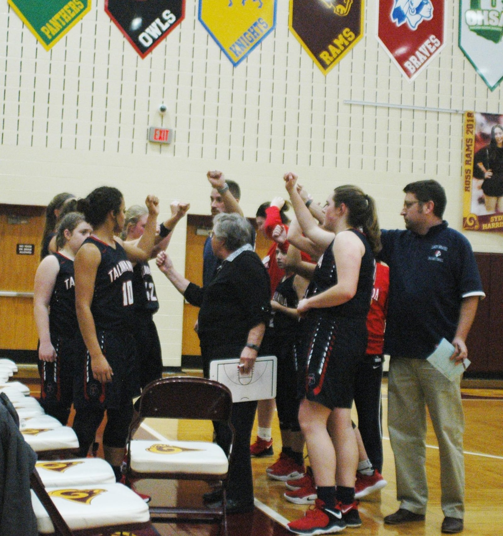 Talawanda coach Mary Jo Huismann (middle) huddles with her team during Wednesday night’s 26-25 loss at Ross. RICK CASSANO/STAFF