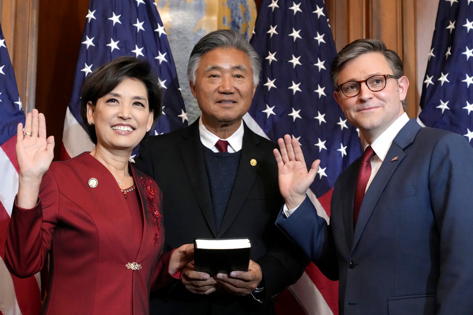 House Speaker Mike Johnson, R-La., right, poses during a ceremonial swearing-in with Rep. Young Kim, R-Calif., left, in the Rayburn Room at the Capitol in Washington, Friday, Jan. 3, 2025. (AP Photo/Jacquelyn Martin)