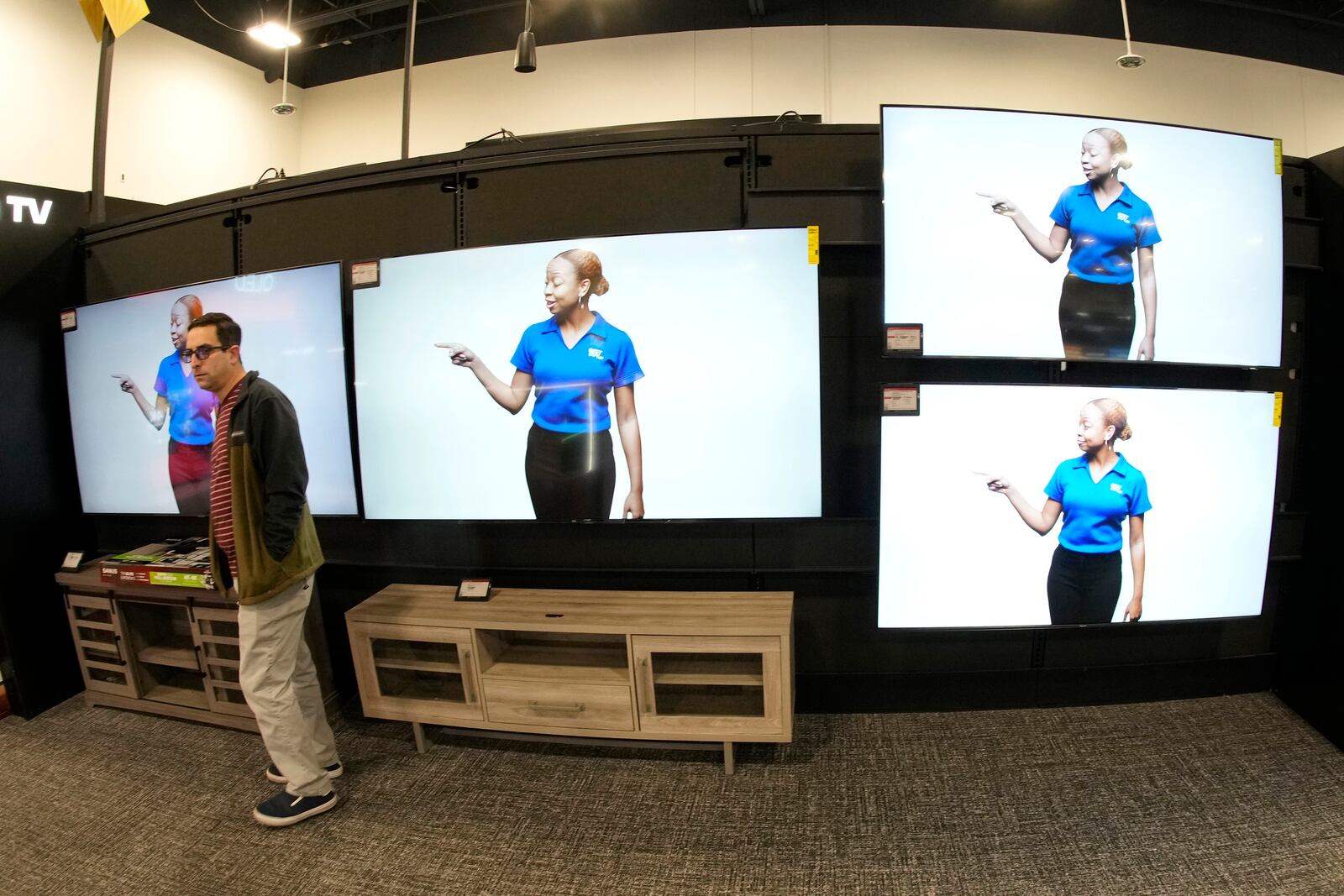 FILE - A customer turns away after looking at big-screen televisions in a Best Buy store Nov. 21, 2023, in southeast Denver. (AP Photo/David Zalubowski, File)