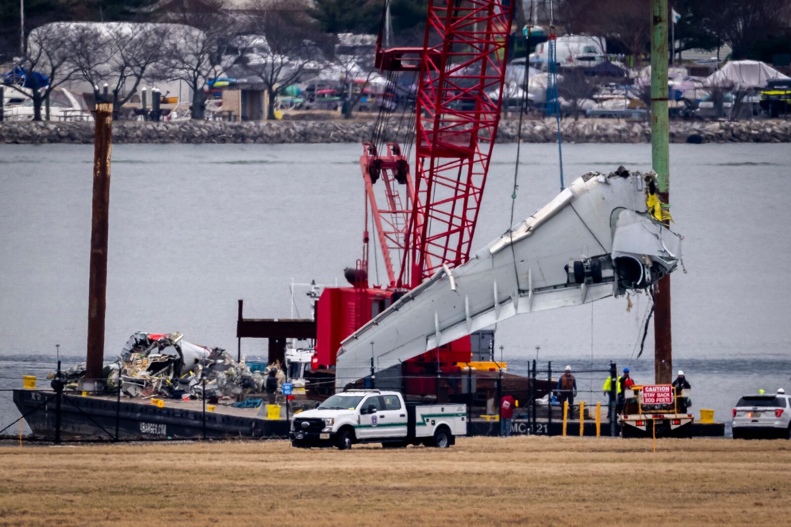 Salvage crews work near the wreckage site in the Potomac River of a mid-air collision between an American Airlines jet and a Black Hawk helicopter, at Ronald Reagan Washington National Airport, Wednesday, Feb. 5, 2025, in Arlington, Va. (AP Photo/Ben Curtis)