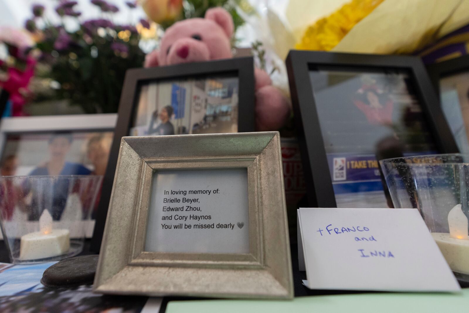 A memorial is seen along the boards at MedStar Capitals Iceplex Sunday, Feb. 2, 2025, in Arlington, Va., for the figure skaters who were among the 67 victims of a mid-air collision between an Army helicopter and an American Airlines flight from Kansas. (AP Photo/Carolyn Kaster)