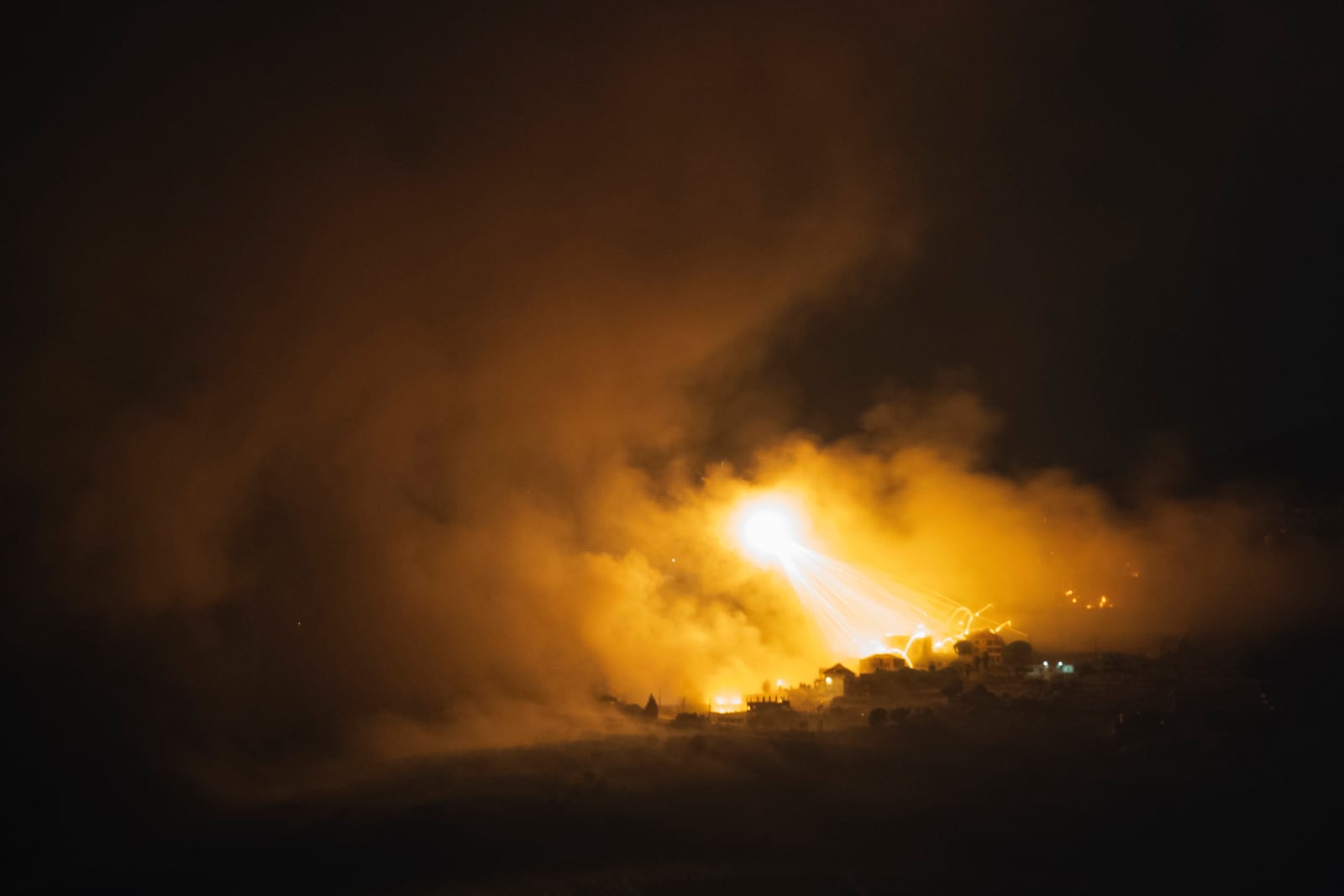 Israeli shelling hits an area in southern Lebanon as seen from northern Israel, early Tuesday, Oct. 1, 2024. (AP Photo/Leo Correa)