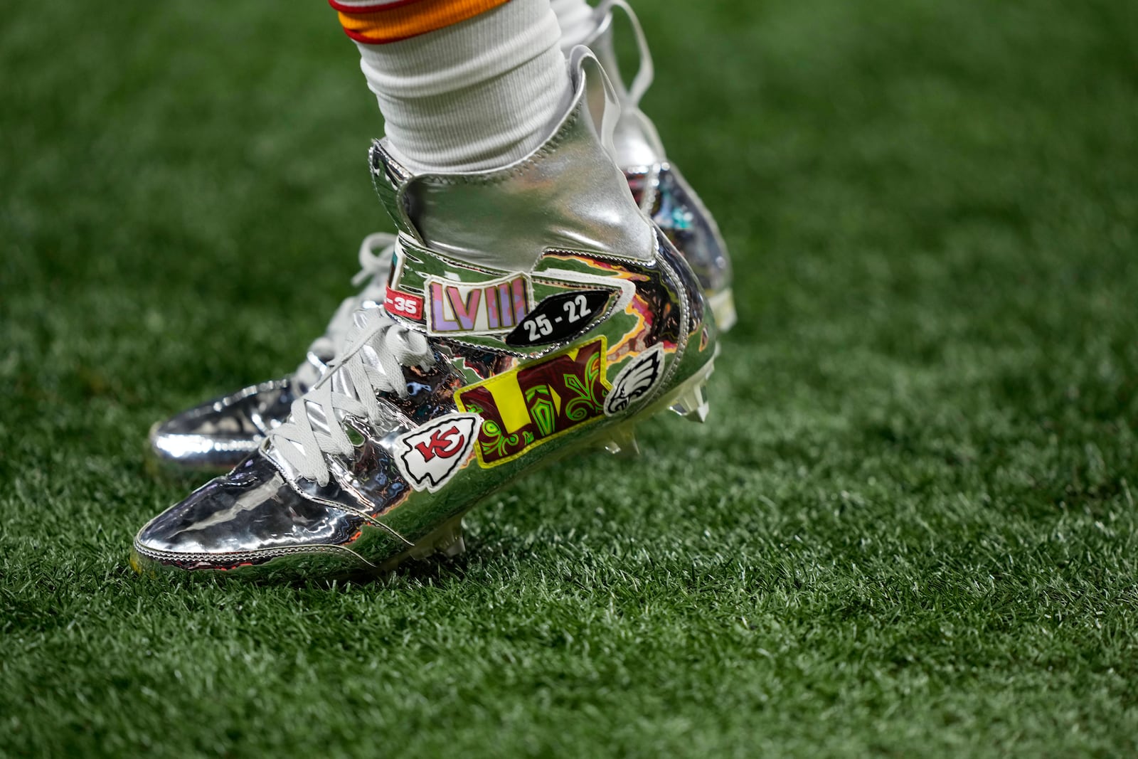 Kansas City Chiefs defensive end Charles Omenihu wears messages on his cleats while warming up before the NFL Super Bowl 59 football game against the Philadelphia Eagles, Sunday, Feb. 9, 2025, in New Orleans. (AP Photo/Doug Benc)