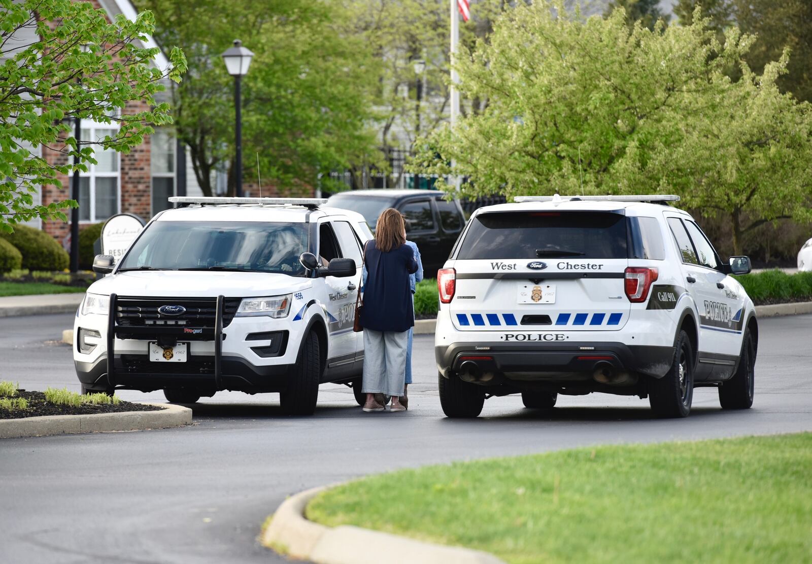 Several investigators remain on the scene Monday morning, hours after four people were found dead inside a unit at the Lakefront at West Chester apartment complex. The deaths of the four are being investigated as homicides, according to police. (Nick Graham/Staff)