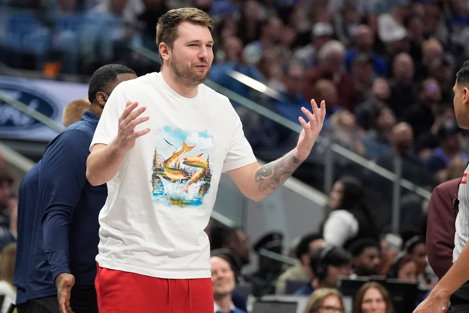 An injured Dallas Mavericks guard Luka Doncic questions a call during the first half of an NBA basketball game against the Oklahoma City Thunder Friday, Jan. 17, 2025, in Dallas. (AP Photo/LM Otero)