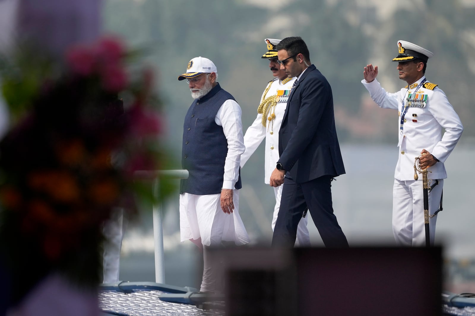 Indian Prime Minister Narendra Modi walks on the deck after the commissioning of INS Surat at a naval dockyard in Mumbai, India, Wednesday, Jan. 15, 2025. (AP Photo/Rafiq Maqbool)