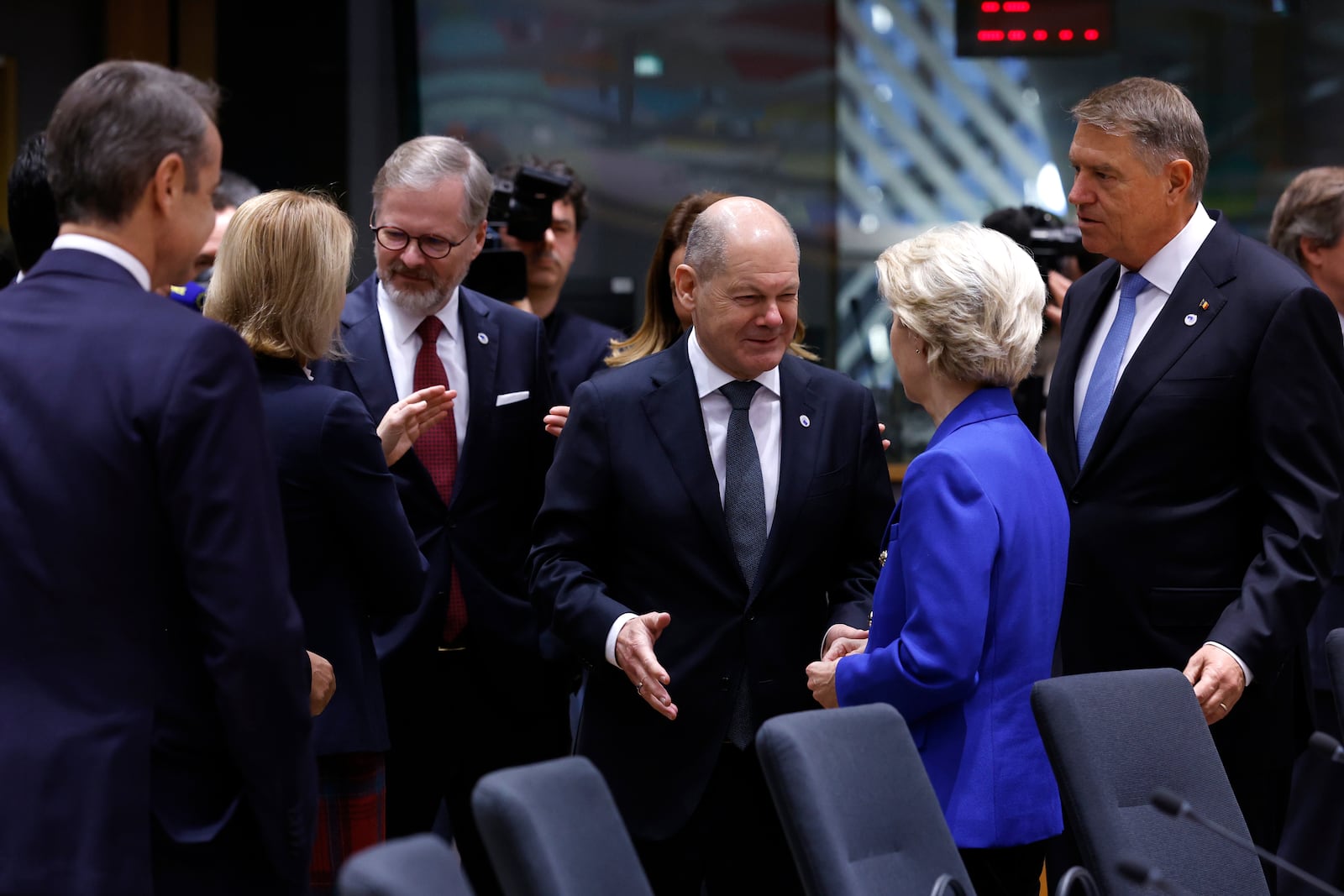 Germany's Chancellor Olaf Scholz, center, speaks with European Commission President Ursula von der Leyen during a round table meeting at an EU summit in Brussels, Thursday, Dec. 19, 2024. (AP Photo/Omar Havana)