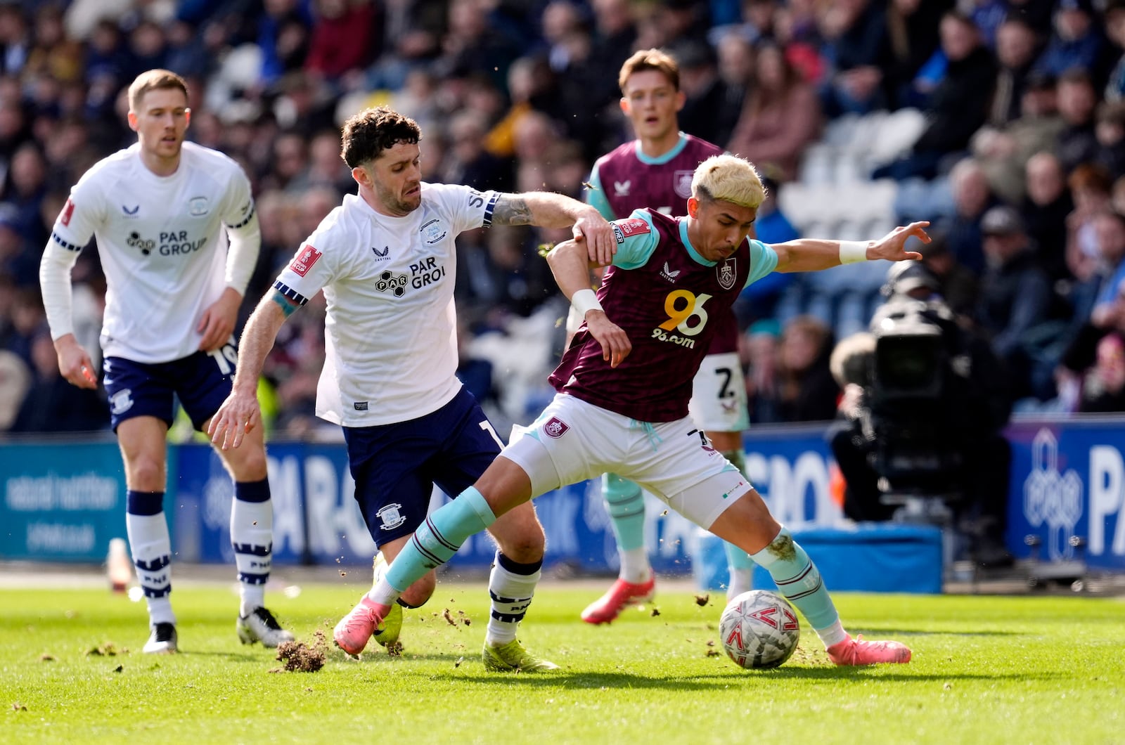 Preston North End's Robbie Brady, center left and Burnley's Jeremy Sarmiento vie for the ball, during the English FA Cup fifth round soccer match between Preston North End and Burnley, at Deepdale, in Preston, England, Saturday, March 1, 2025. (Nick Potts/PA via AP)