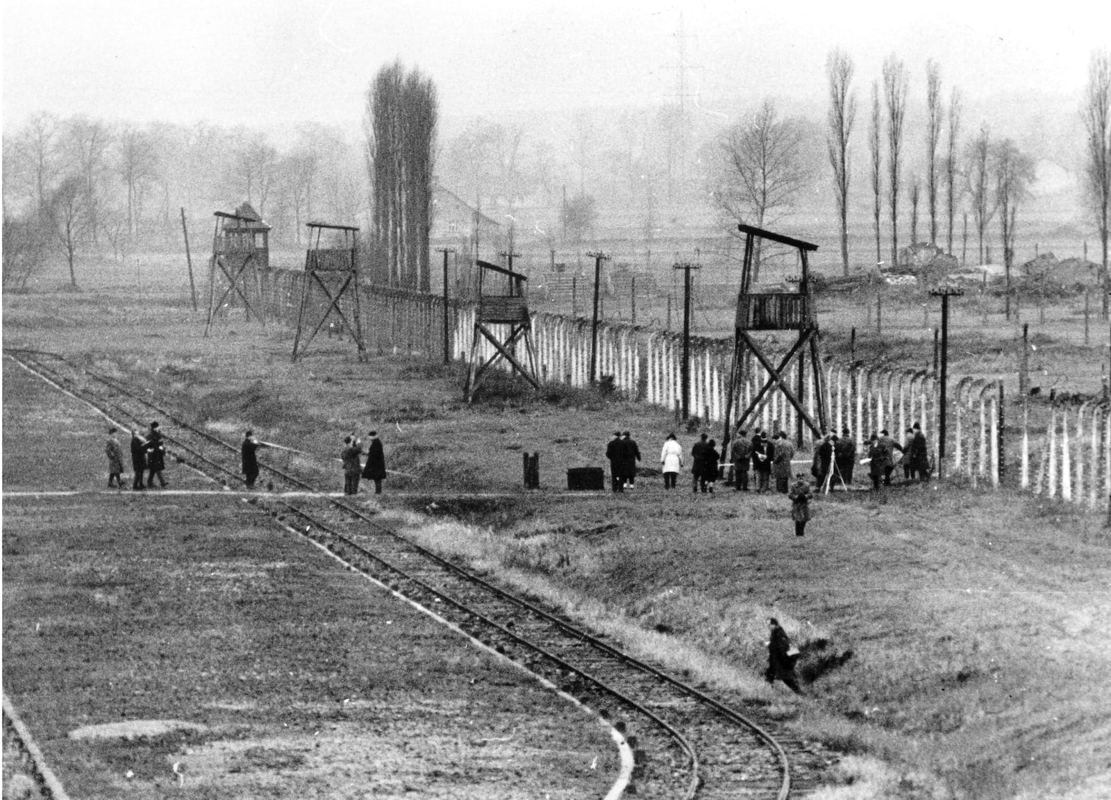 FILE - Part of the Auschwitz war crimes court inspects the former Nazi extermination center in Poland in Dec. 1964, where more than four million, mostly Jews, perished during World War II, from 1940 until 1945. (AP Photo, File)