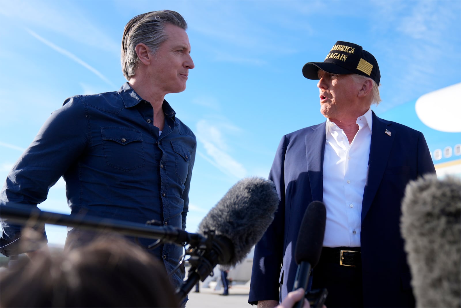 President Donald Trump talks with California Gov. Gavin Newsom after arriving on Air Force One at Los Angeles International Airport in Los Angeles, Friday, Jan. 24, 2025. (AP Photo/Mark Schiefelbein)