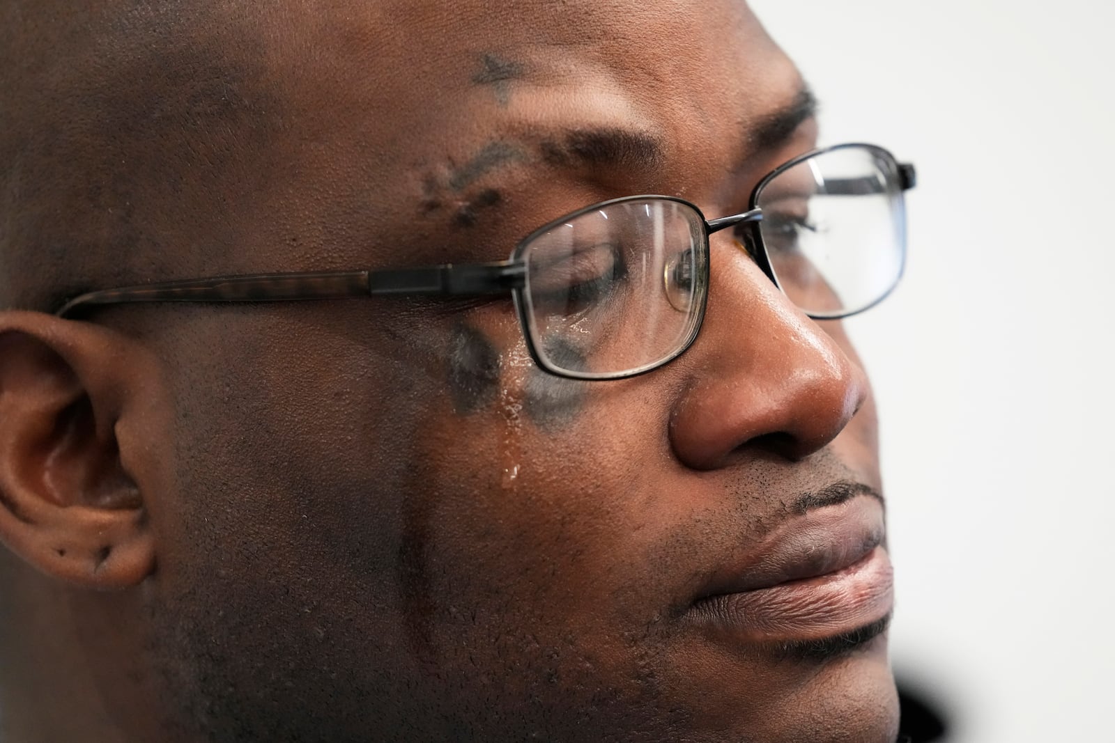 Sexual assault survivor Marcus Walker cries as he listens to Attorney Jerome Block, speak during a news conference in Chicago, Tuesday, Feb. 11, 2025. (AP Photo/Nam Y. Huh)