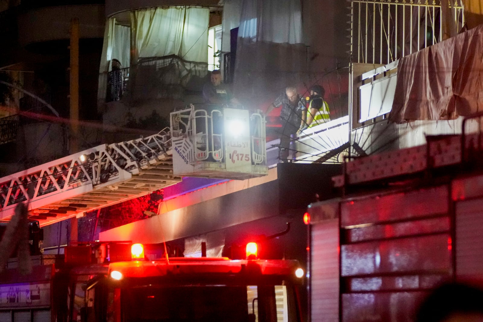 Emergency workers rescue an elderly man from a damaged building hit by an Israeli airstrike at the site of an Israeli airstrike in Beirut, Lebanon, Thursday, Oct. 10, 2024. (AP Photo/Hassan Ammar)