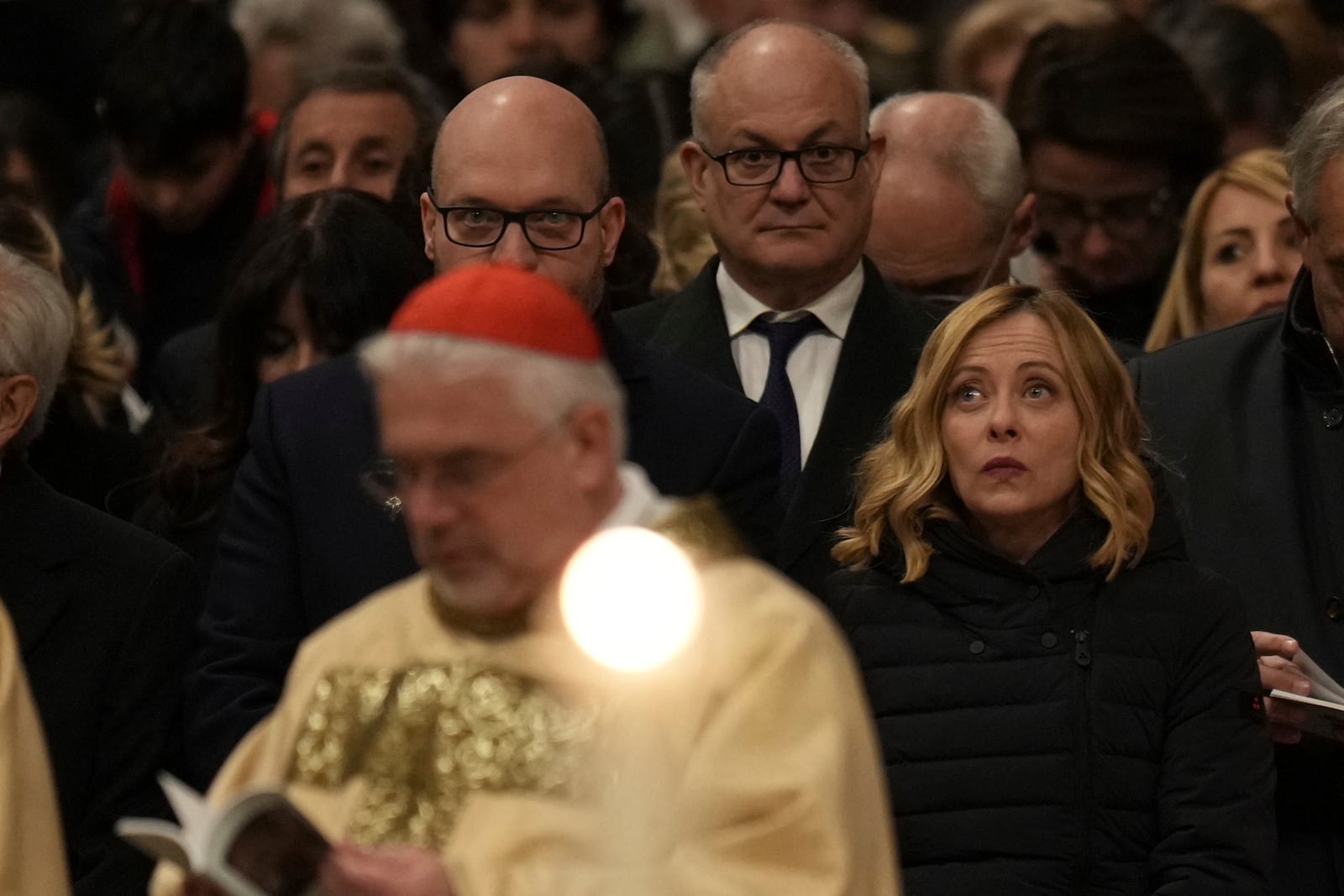 From right, Italian Premier Giorgia Meloni, Rome's Mayor Roberto Gualtieri, and House Speaker Lorenzo Fontana attend the Christmas Eve Mass in St. Peter's Basilica at The Vatican, Tuesday, Dec. 24, 2024, presided over by Pope Francis after opening the basilica's holy door marking the start of the Catholic jubiliar year 2025. (AP Photo/Andrew Medichini)