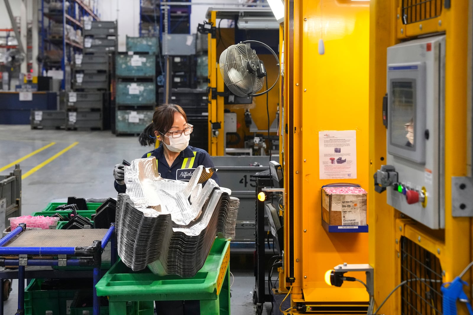 FILE - An employee works on the production line at the Martinrea auto parts manufacturing plant that supplies auto parts to Canada and U.S. plants, in Woodbridge, Ontario, Monday, Feb. 3, 2025. (Chris Young/The Canadian Press via AP, File)