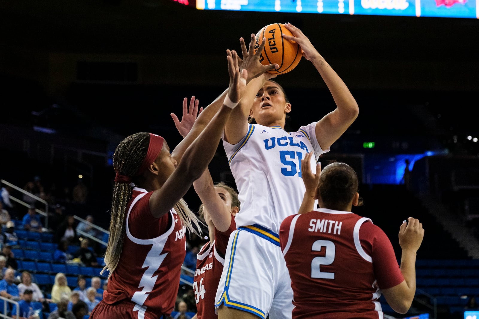 UCLA center Lauren Betts (51) looks to shoot over Arkansas players during the first half of an NCAA college basketball game Sunday, Nov. 17, 2024, in Los Angeles. (AP Photo/William Liang)