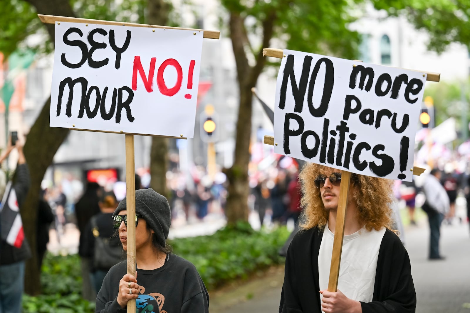 Protesters march carrying placards to New Zealand's parliament to demonstrate against a proposed law that would redefine the country's founding agreement between Indigenous Māori and the British Crown, in Wellington, New Zealand, Tuesday, Nov. 19, 2024. (AP Photo/Mark Tantrum)