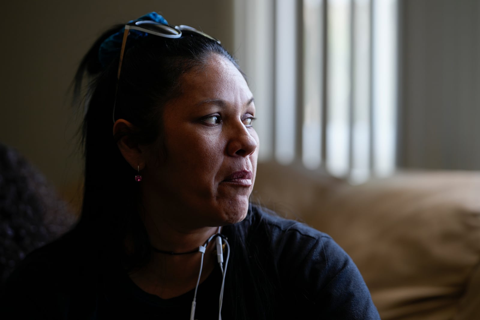 María Ángel Torres looks out the window during an interview at her apartment Friday, May 18, 2024, in Aurora, Colorado. (AP Photo/Jack Dempsey)