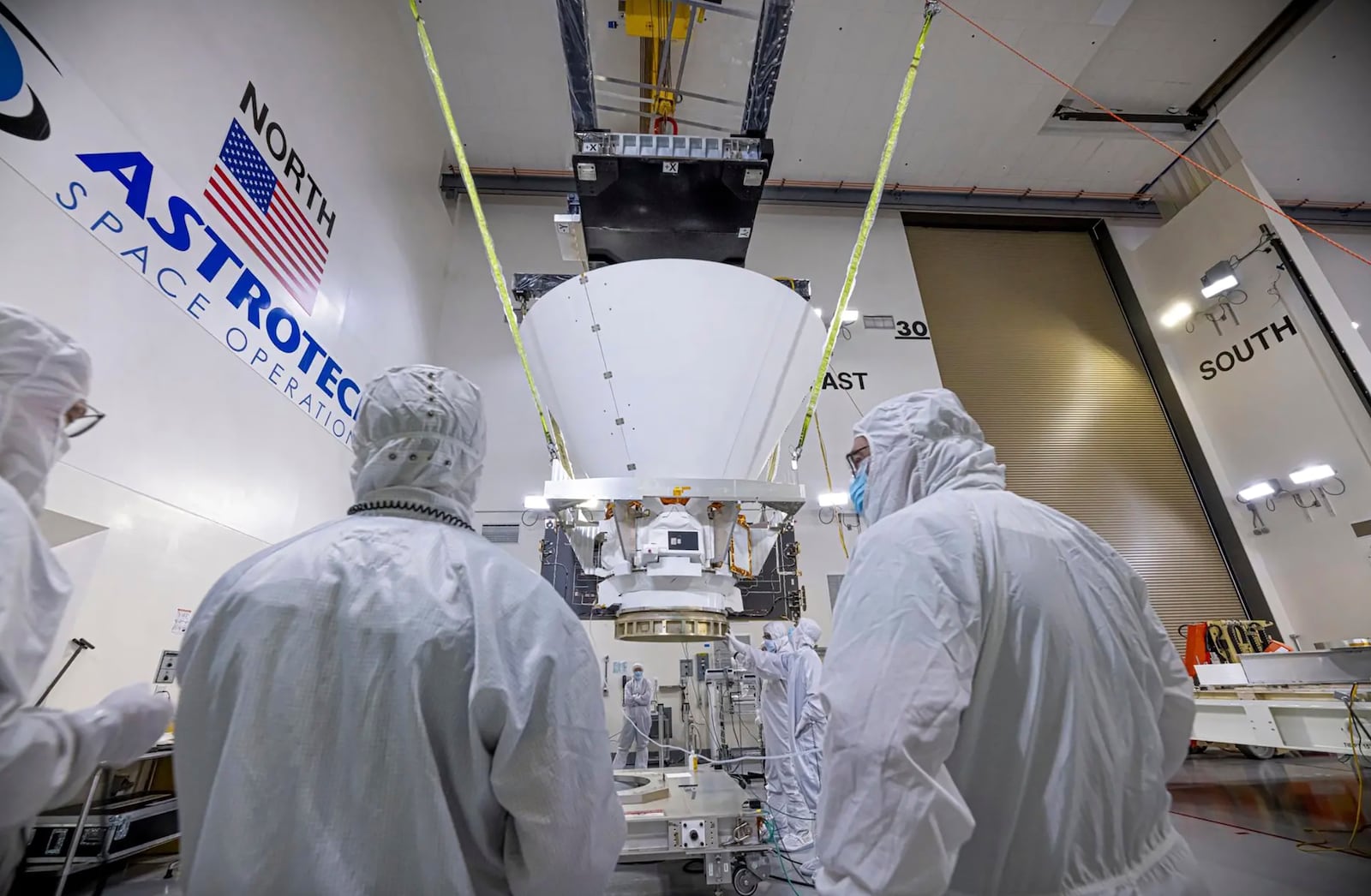 This image provided by NASA shows BAE Systems employees working on NASA’s SPHEREx observatory in the Astrotech Space Operations facility at Vandenberg Space Force Base in California on Jan. 16, 2025. (NASA via AP)