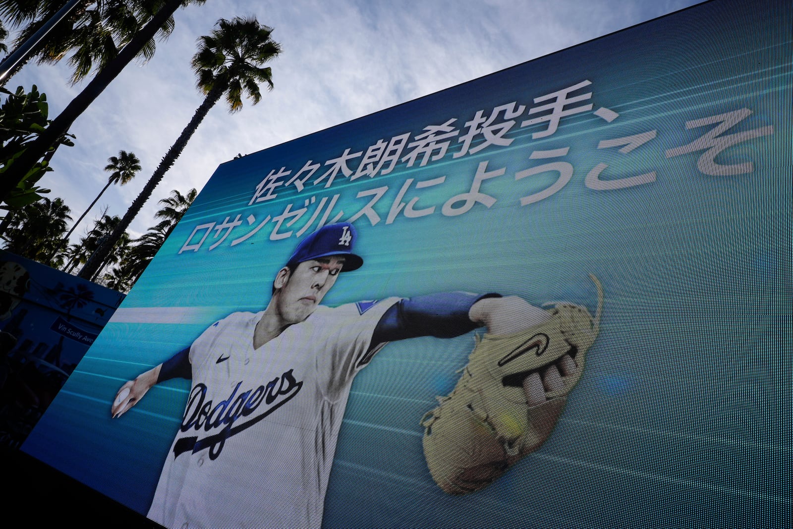 Digital display of Japanese right-hander pitcher Roki Sasaki, 23, appears at Dodger Stadium before he is introduced by the Los Angeles Dodgers at a news conference Wednesday, Jan. 22, 2025 in Los Angeles. (AP Photo/Damian Dovarganes)