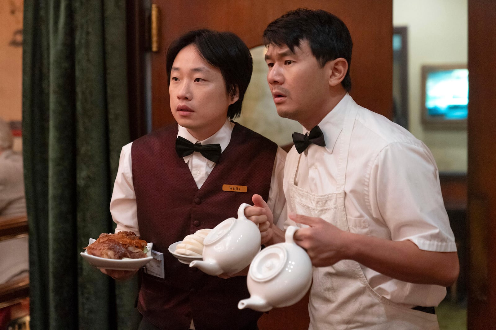 This image released by Hulu shows Jimmy O. Yang, left, and Ronny Chieng in a scene from the series "Interior Chinatown." (Mike Taing/Hulu via AP)